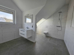 **Neubau-Erstbezug in Stadecken-Elsheim** Luxuriöse Doppelhaushälfte in gewachsener 1-A Wohnlage - Gartengeschoss